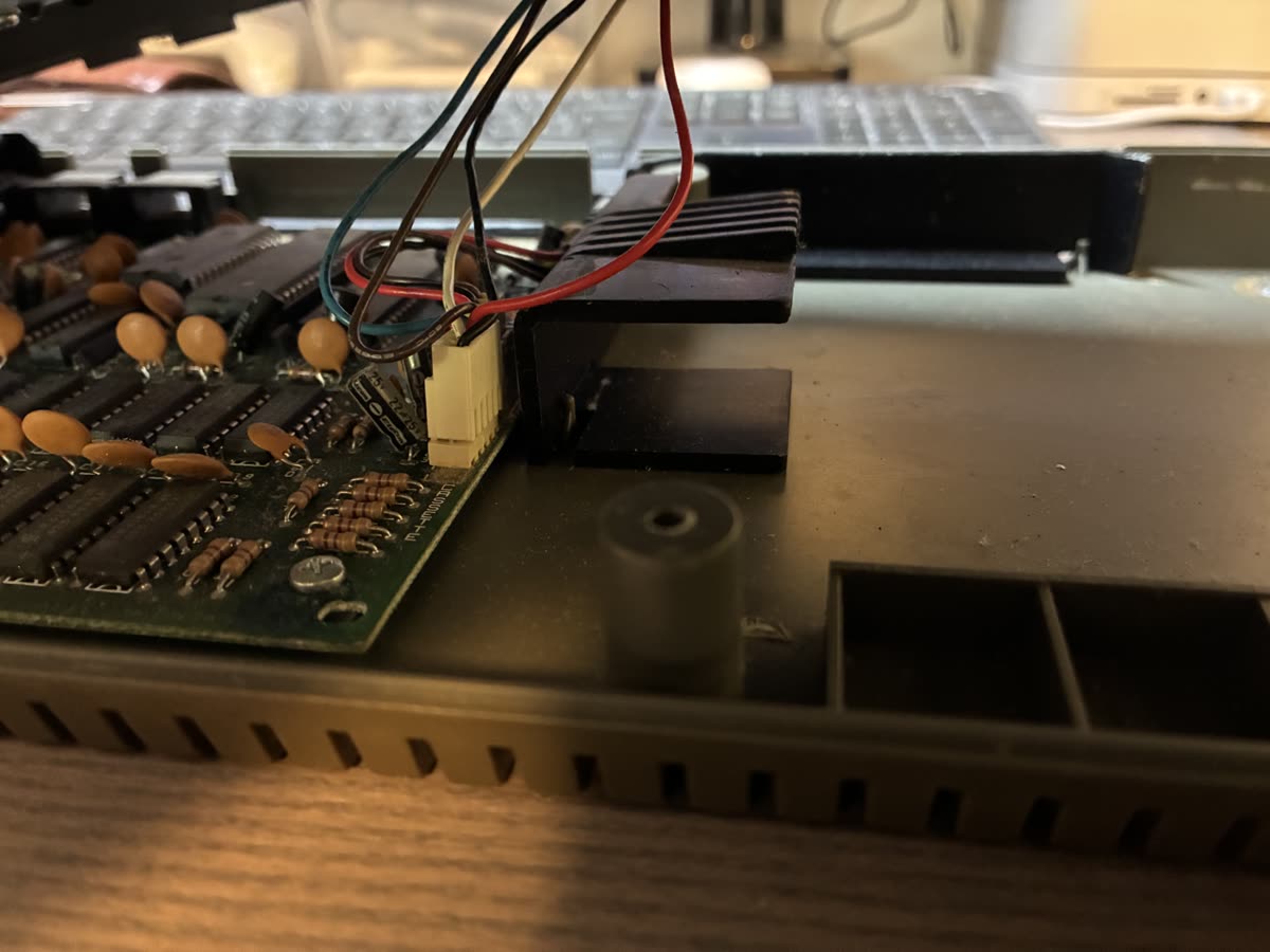 The +2 case partly open, with coloured wires and a connector still joining the two halves.