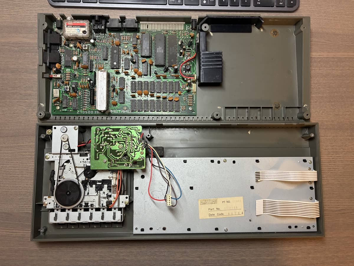 The opened ZX Spectrum +2: the Amstrad main board in one half of the case, and the Datacorder mechanism and keyboard plate in the other.
